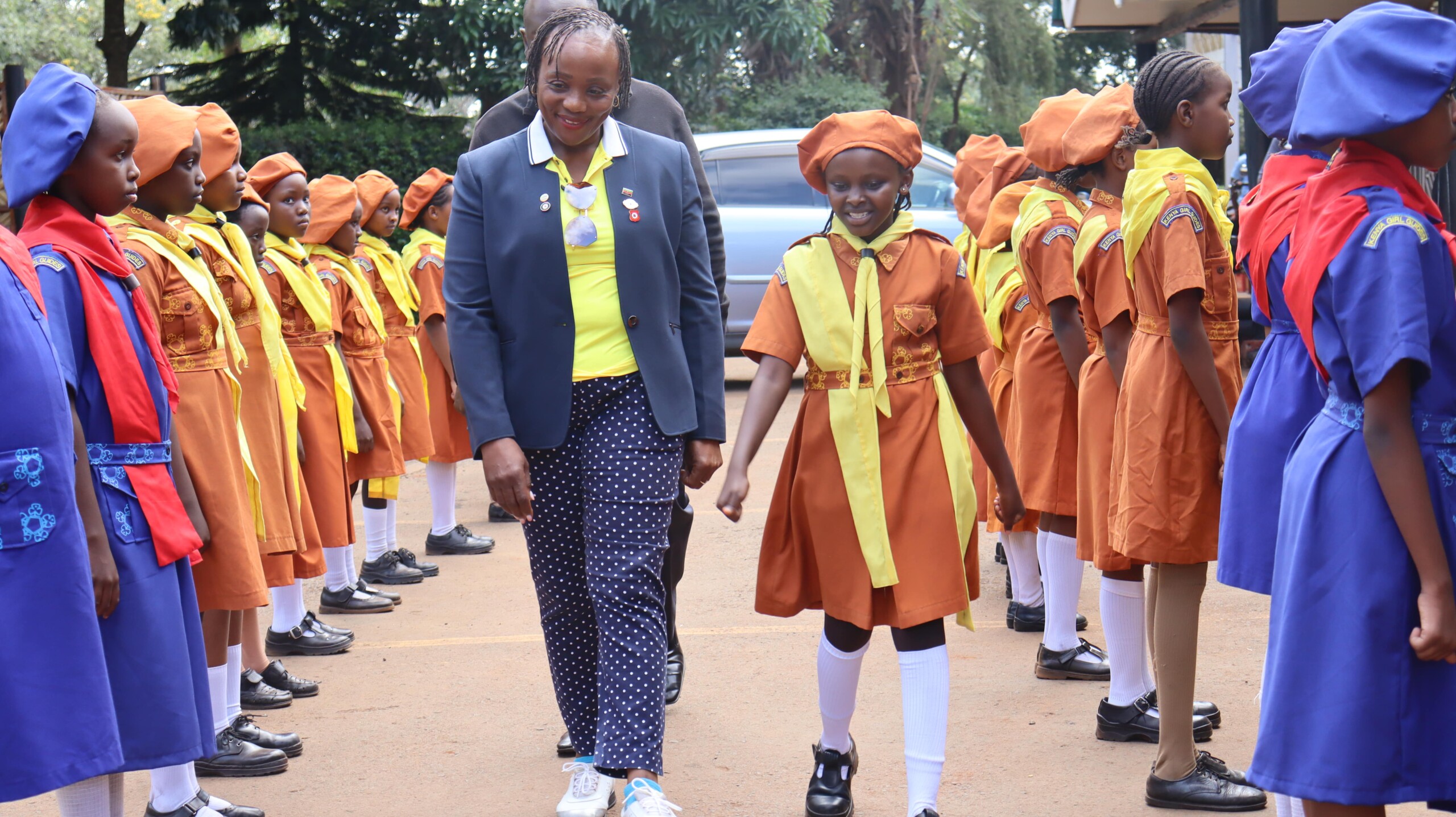 KLGU Chairman Rosemary Olonde inspects a guard of honor at Thika Sports Club with the Girl Guides